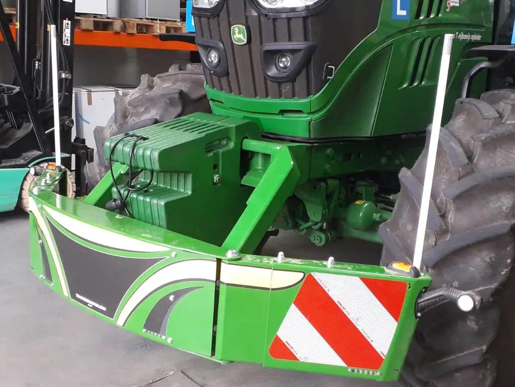 Green tractor fitted with a Box 50L without front linkage, featuring reflective stripes and safety posts