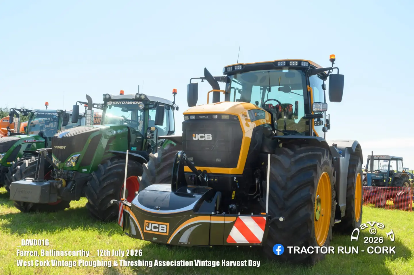 Yellow and black tractor fitted with a front weight bumper with LED lights and reflective panels on grass