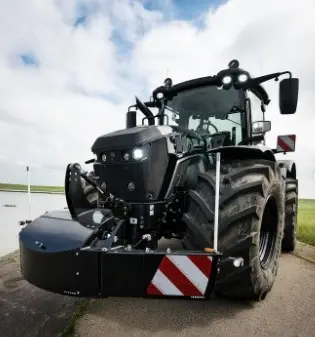 A large black tractor with a mounted front weight bumper featuring reflective red and white safety stripes