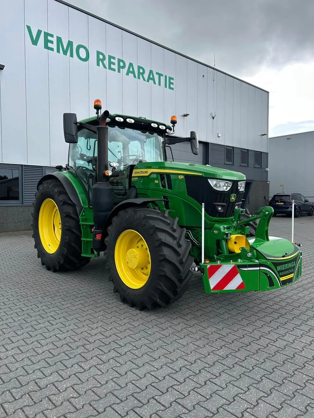 John Deere tractor with a TractorBumper front bumper and rear weight