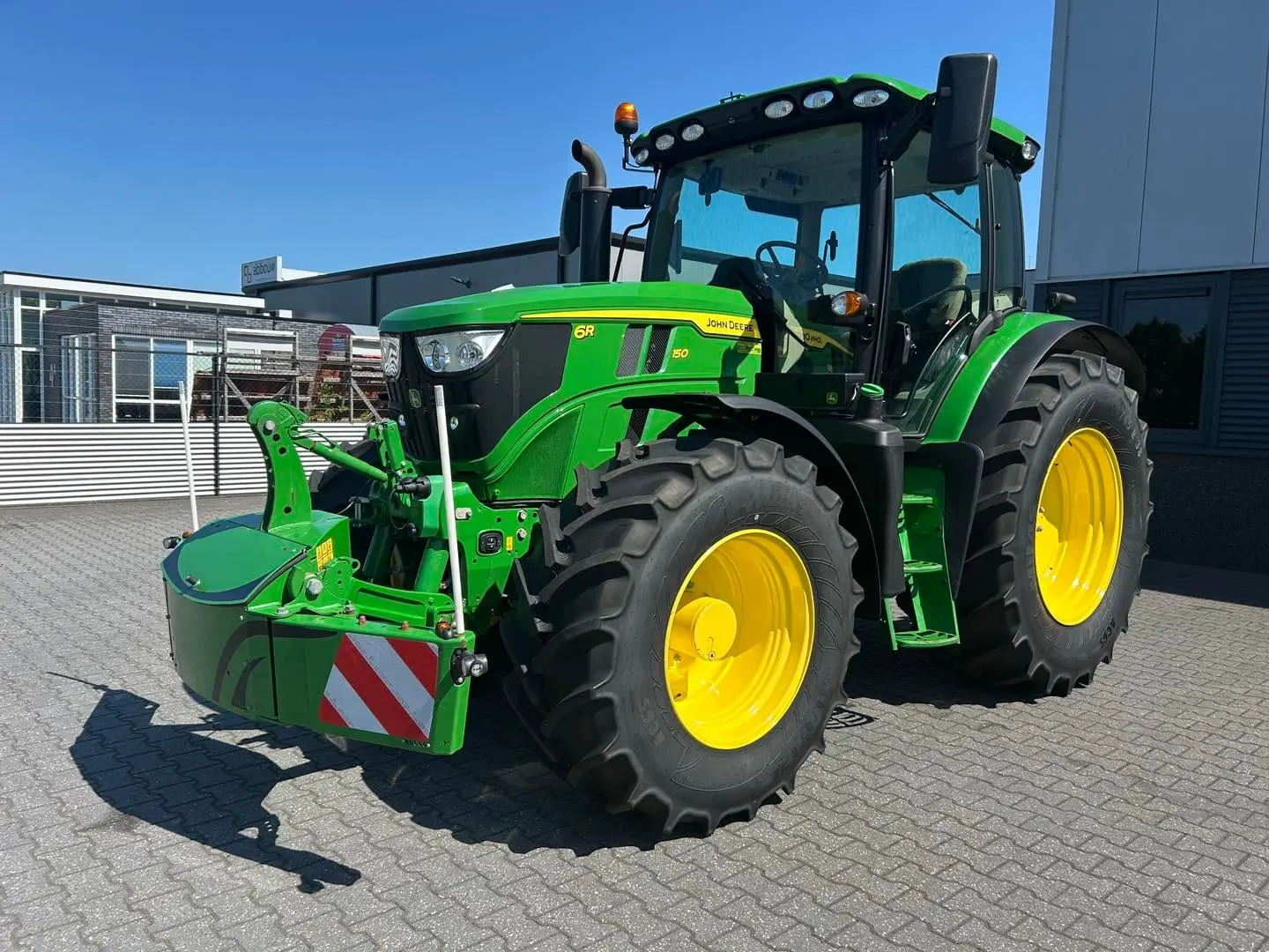 John Deere tractor with a TractorBumper front bumper and rear weight
