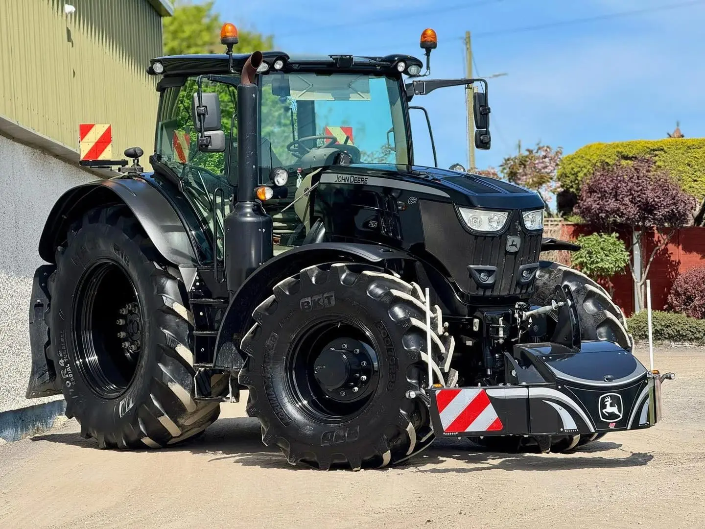 John Deere tractor with a TractorBumper front bumper and rear weight