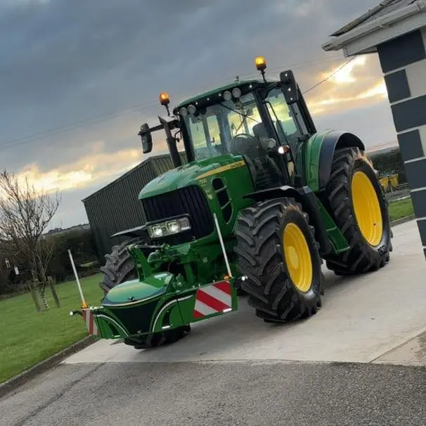 John Deere tractor with a TractorBumper front bumper and rear weight